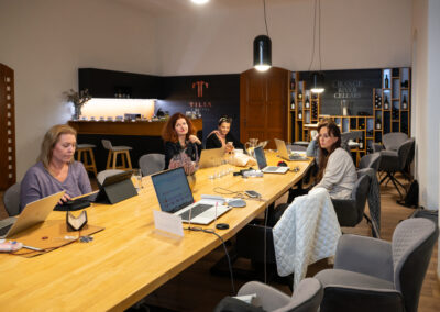 Účastnice workshopu Canva pro firmy pracují na noteboocích